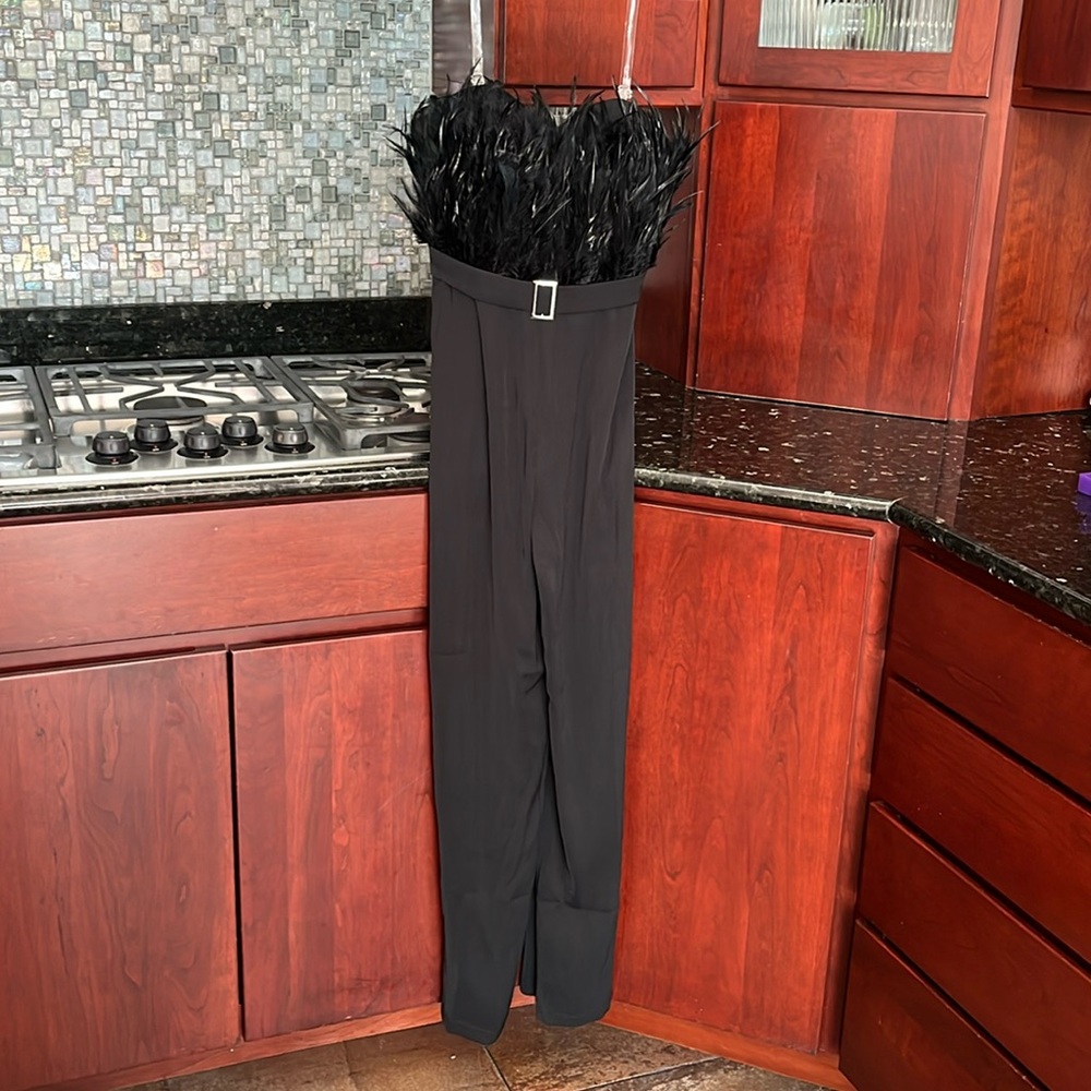 Black size medium(6) jumpsuit can be worn with or out clear straps. Back zipper